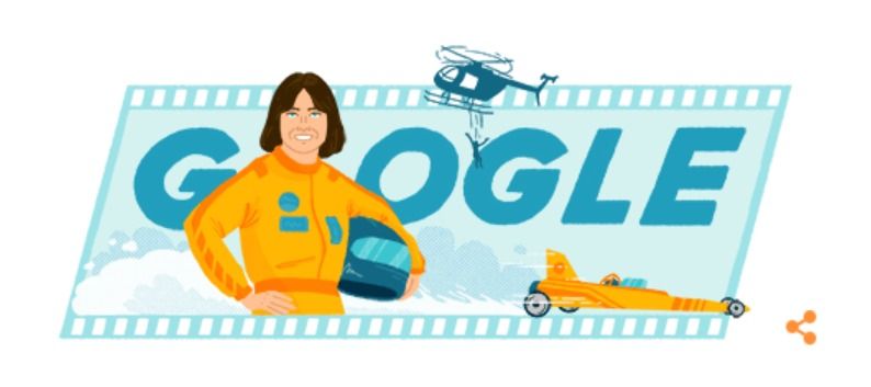 Ilustração do Google em homenagem à Kitty O'neil. em que ela aparece segurando um capacete. Ao fundo há um carro de corrida e um helicóptero com uma pessoa saltando para fazer alusão a sua carreira automobilista e como dublê.